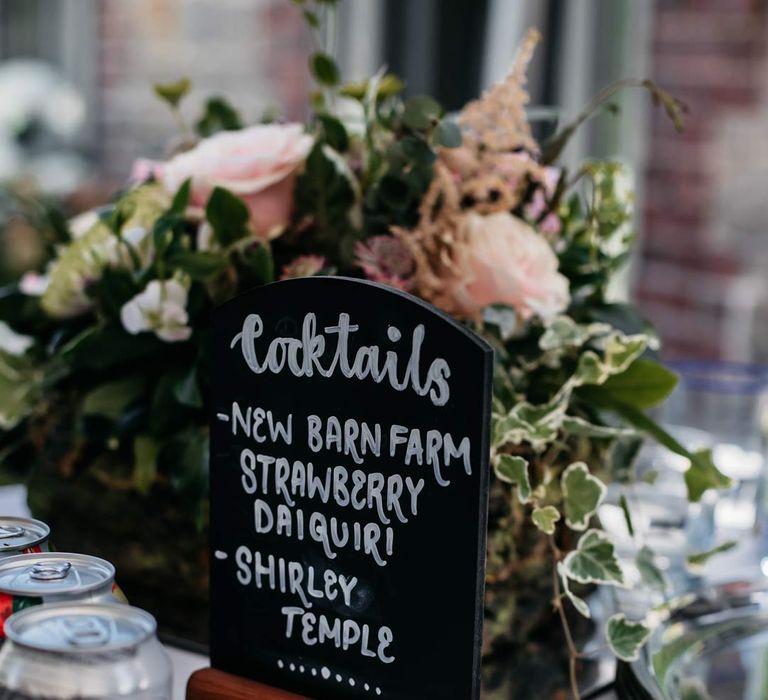 Wedding cocktails menu on black chalkboard wedding sign