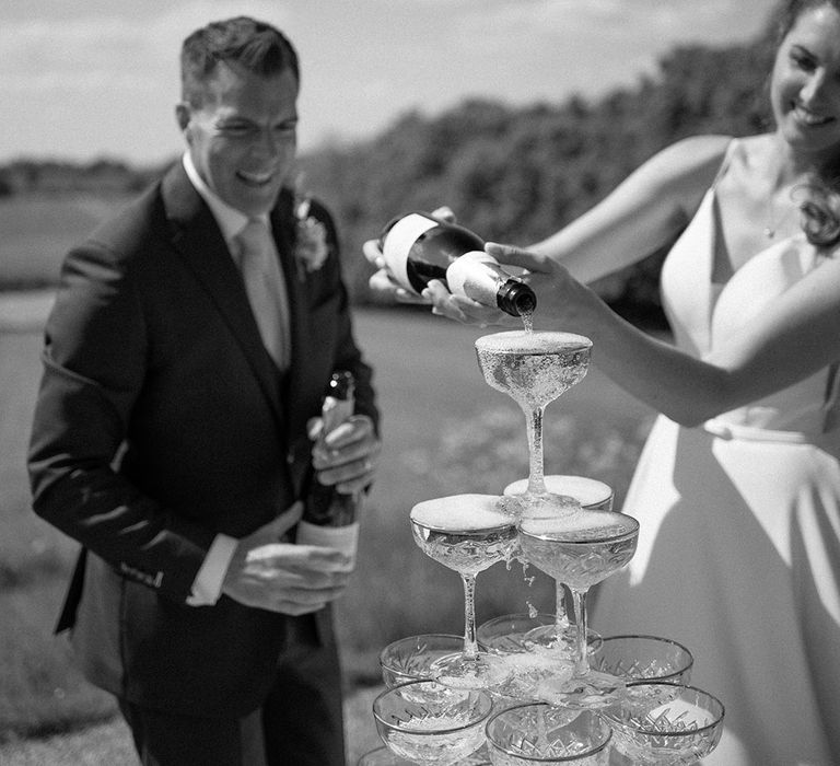 The bride and groom with their stunning wedding champagne tower 