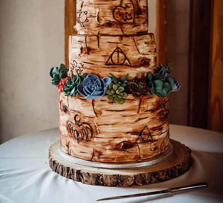 Tree trunk style iced wedding cake with personalised cake topper 