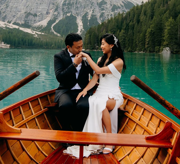 Bride and groom on a row boat in The Dolomites 