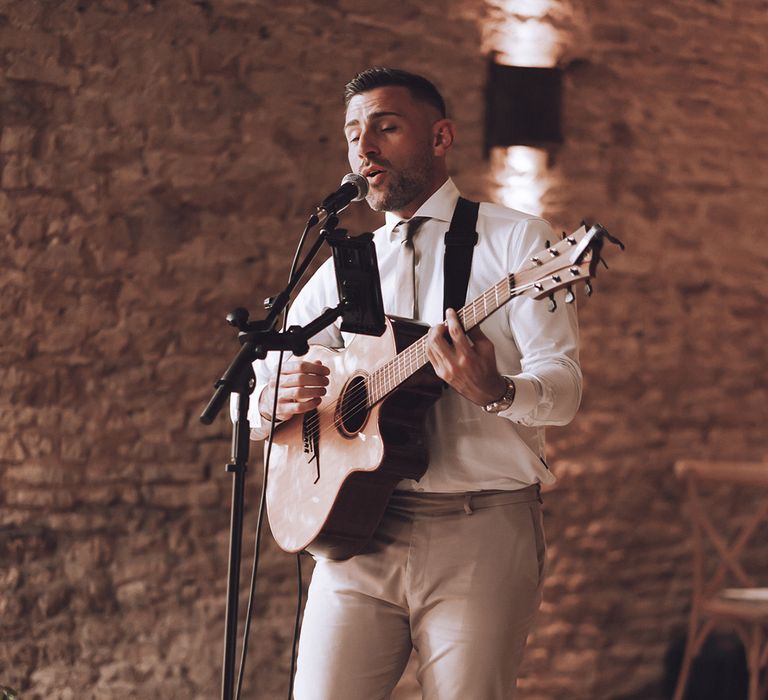 Wedding singer with acoustic guitar singing at the wedding 