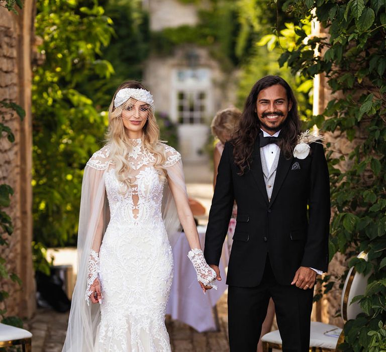 Stylish bride in lace Wona Concept wedding dress and groom in black suit at Euridge Manor 