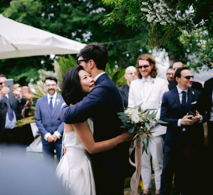 Bride and groom embracing at wedding ceremony 