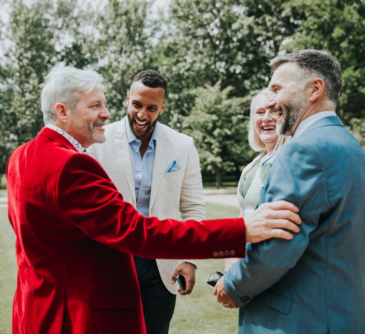 Wedding guests chat on the lawns at The Tythe Barn