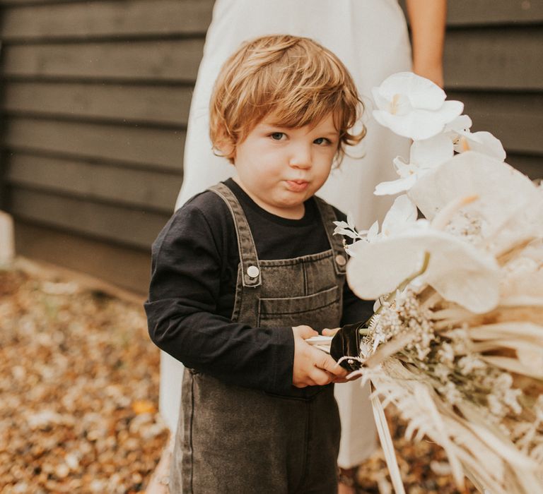 Little boy in denim dungarees at micro wedding 