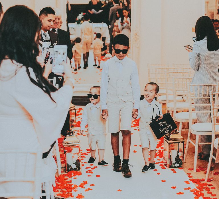 Children walk down the aisle during wedding ceremony