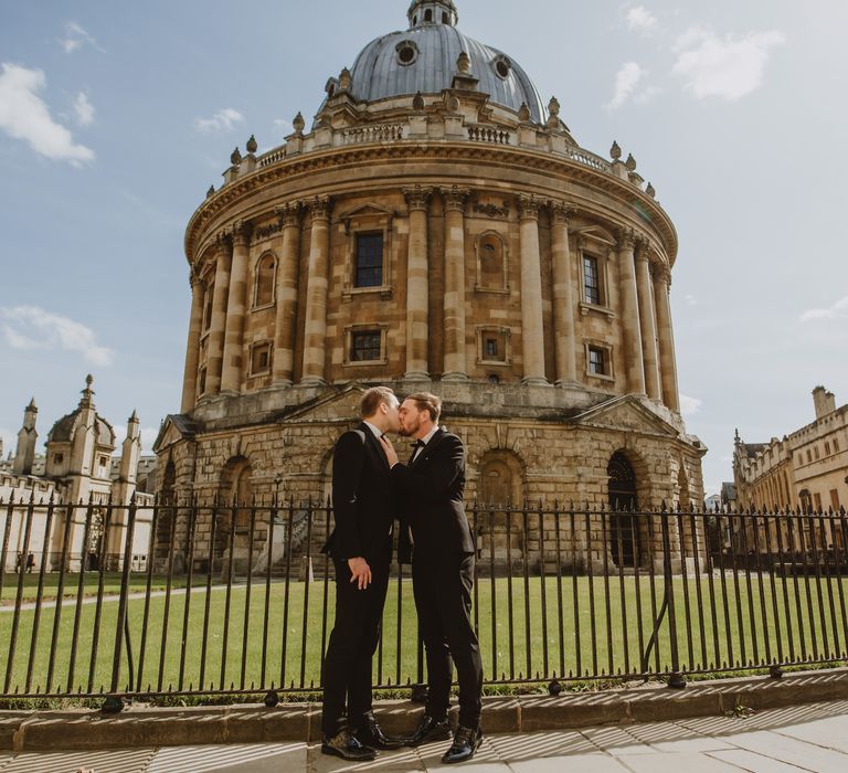 Grooms kiss in Oxford after wedding ceremony