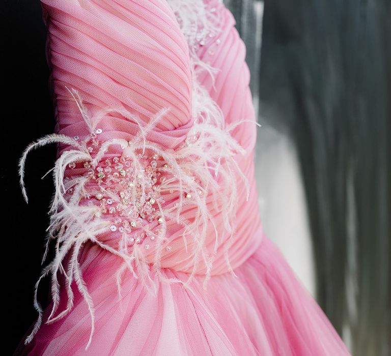 Pink bridal gown with pink feathers and sequinned embellishment and tulle skirt