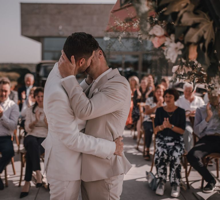 Grooms kiss at same-sex wedding ceremony