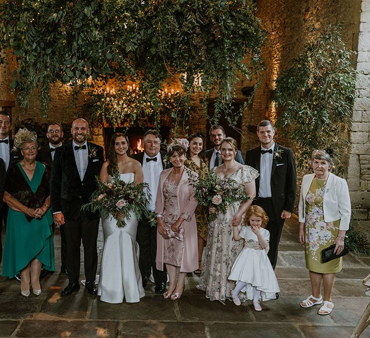 Family portrait at intimate Cripps Barn wedding with natural wedding flower decor