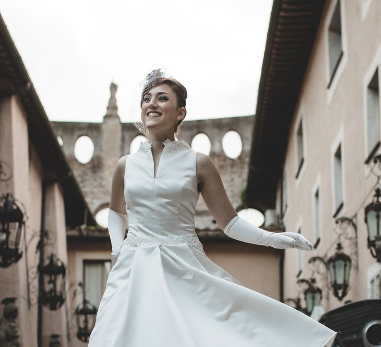 Bride twirling in her vintage style mid length wedding dress 