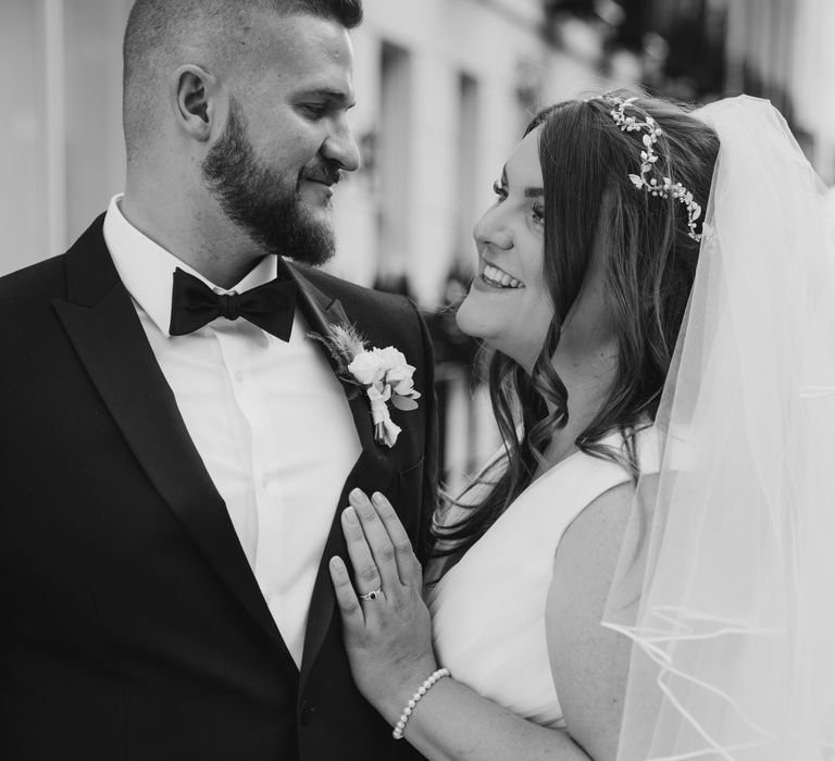 Black & white image of bride & groom looking lovingly at one another on their wedding day