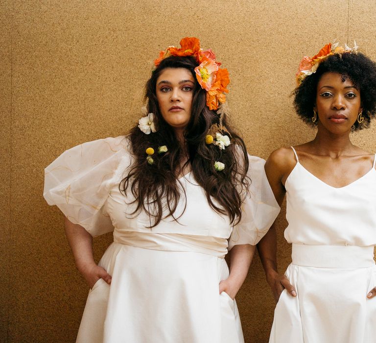 Brides with fresh flower hair accessories, wearing puff sleeve and spaghetti strap bridal separates from Paper To Lace