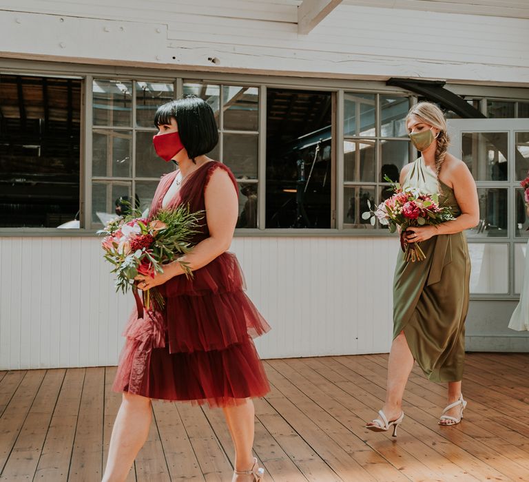 Bridesmaids walk down the aisle at the Boiler House Newcastle for wedding ceremony whilst wearing green coloured face coverings