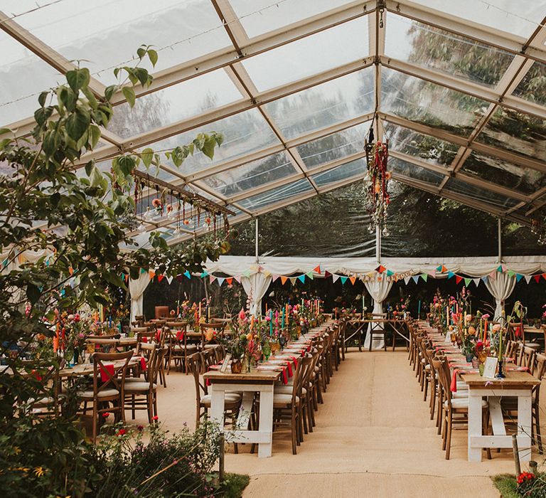 clear span marquee wedding reception with glass roof and colourful wedding table decor 