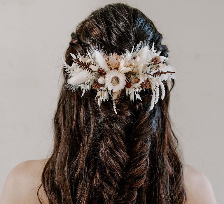 Half up half down wedding hairstyle with fishtail braid and dried flower hair accessory 