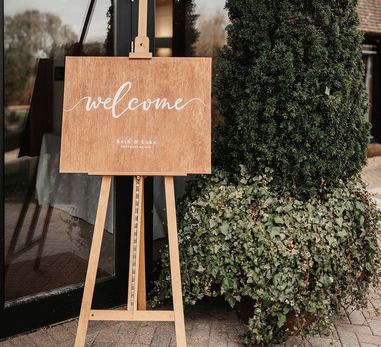 Wooden wedding sign at barn venue