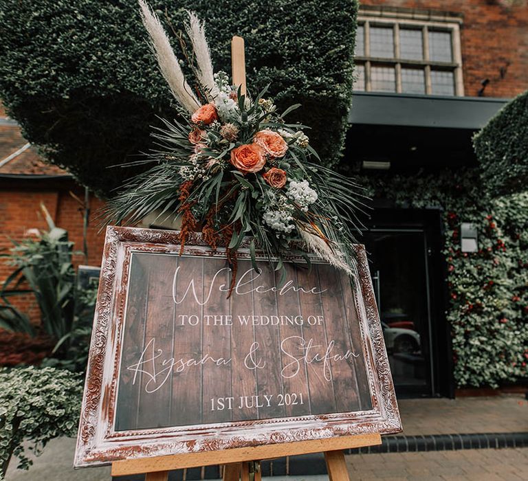 Personalised wedding sign complete with orange pampas grass and green foliage