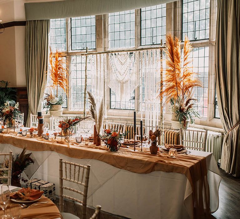 Boho chic tablescape and styling for wedding day with pops of orange 