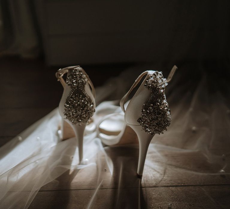 White wedding heels with embellishments on pearl wedding veil bridal accessories 