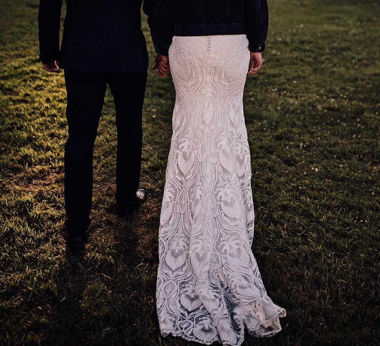 Bride in black denim jacket with embroidered personalised detail with groom in blue tuxedo