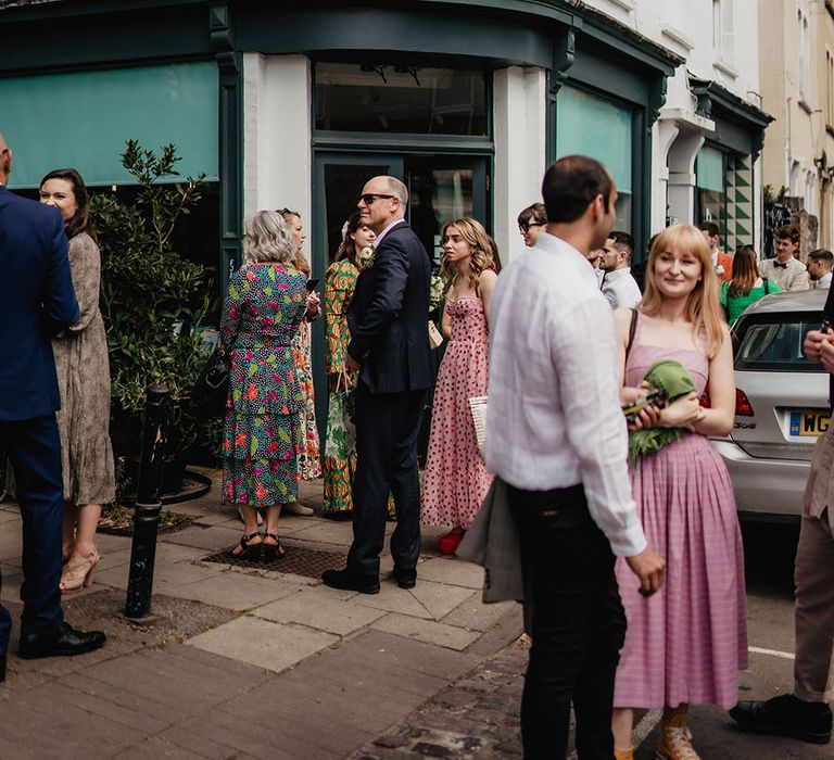 Wedding guests gather outdoors before wedding reception at restaurant in Bristol 