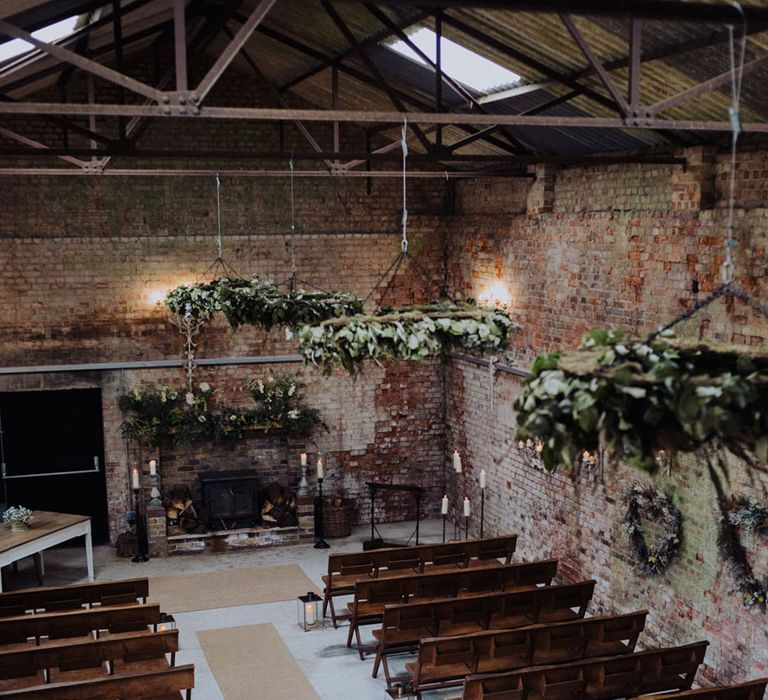 The Barn at Botley Hill wedding ceremony room decorated with foliage 