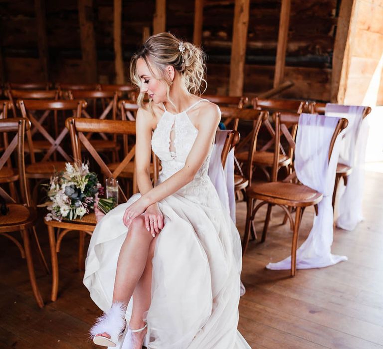 Bride with blonde updo wearing a halter neck keyhole cut tulle wedding dress 