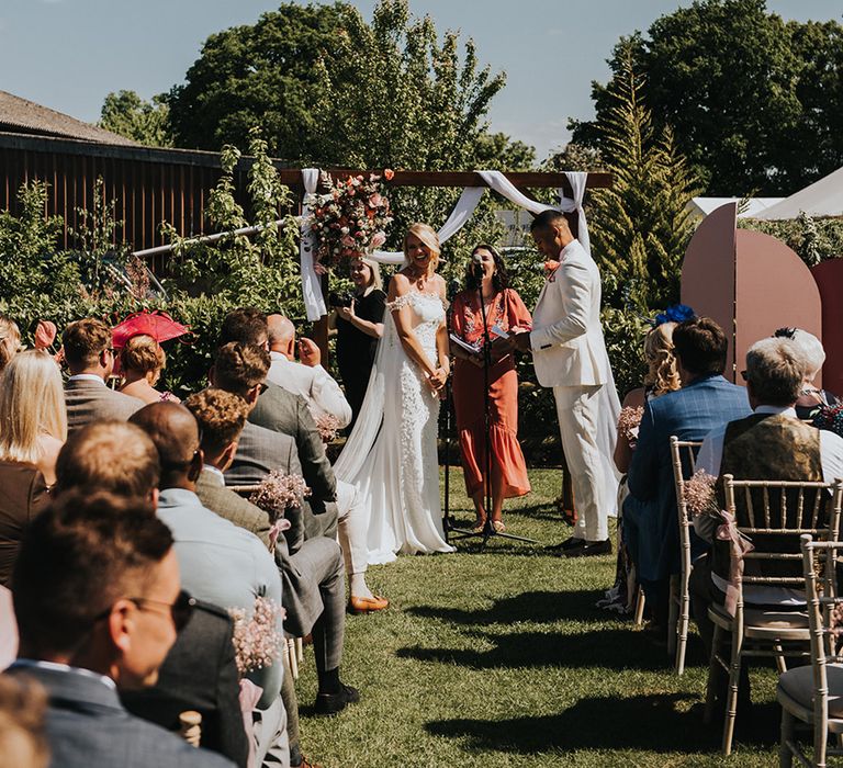 Smiling bride and groom on their wedding day for their outdoor ceremony at The Dinney 