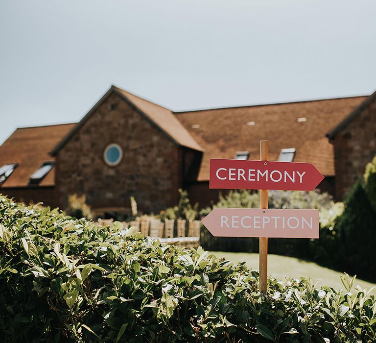 Pink and red wedding direction signs 