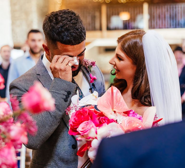 Groom becomes emotional has his bride reaches him once she has walk down the aisle at Priston Mill 