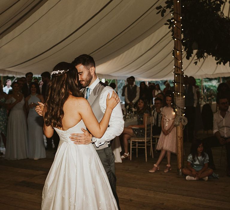 Bride and grooms share their first dance as a married couple together at their marquee reception 