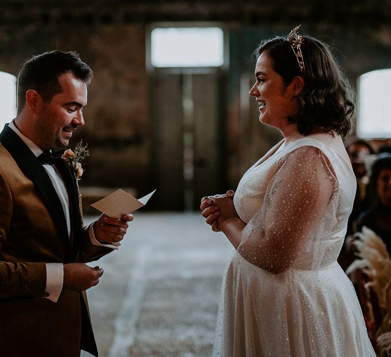 Groom reads vows to Bride at industrial wedding venue in London