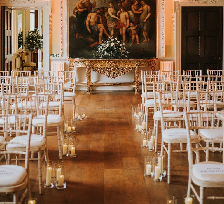 Grand country house wedding ceremony room with pillar candle aisle decor 