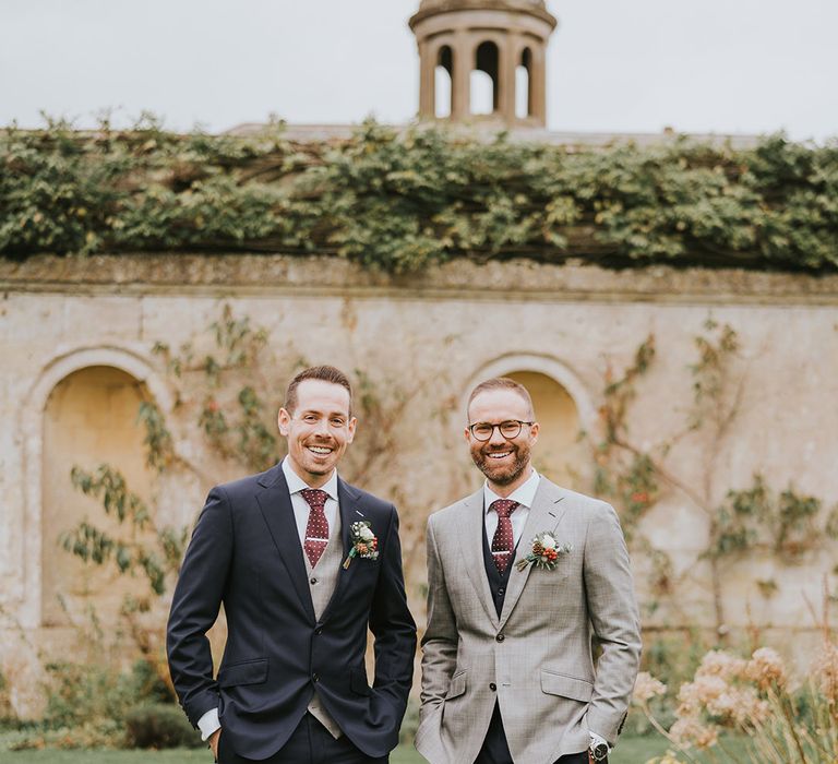 The grooms stand together for their wedding day 