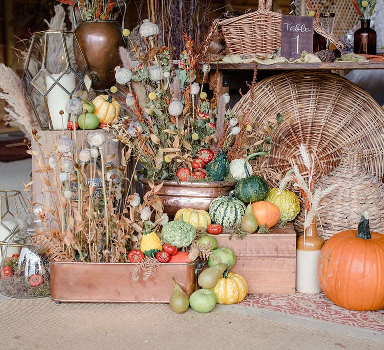 The autumn harvest of gourds, pumpkins and last fruits from the trees added to the backdrop of a harvest wedding