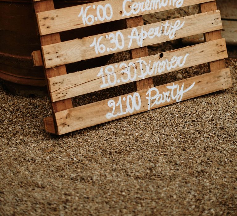 Rustic pallet order of day signage at destination wedding Italy 