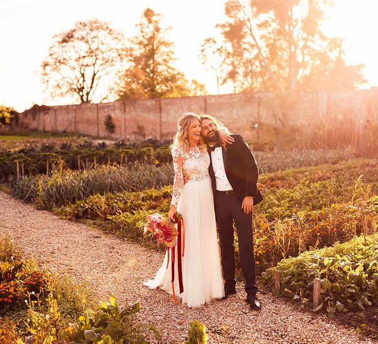 Golden hour wedding photo of the bride and groom at their classic black tie country house wedding 