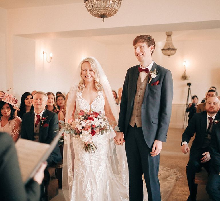 Romantic civil ceremony with bride and groom at red and white theme wedding 