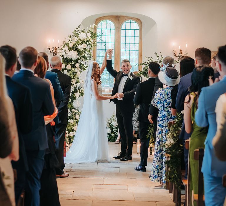 Traditional wedding ceremony with the bride and groom saying their vows at the altar 