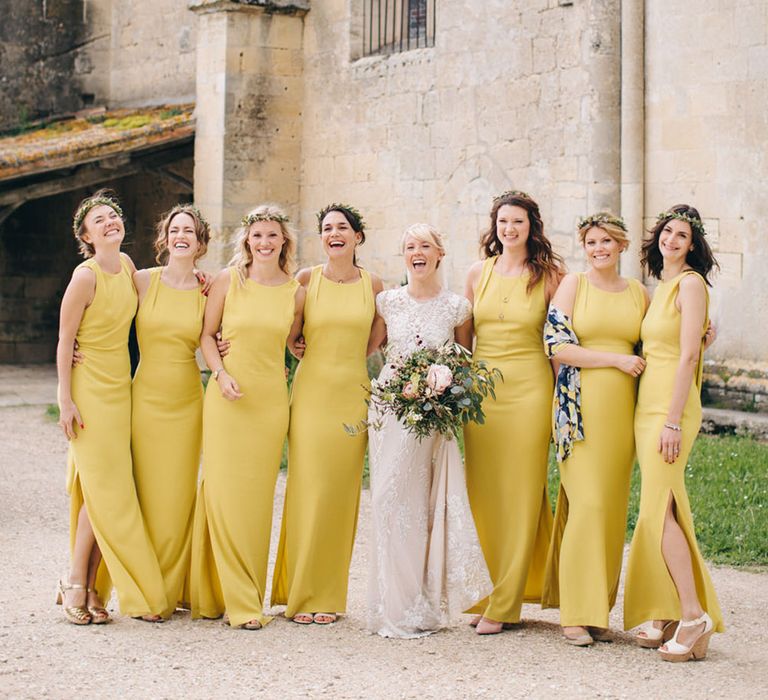 Bridal party wearing yellow bridesmaid dresses for yellow theme wedding 