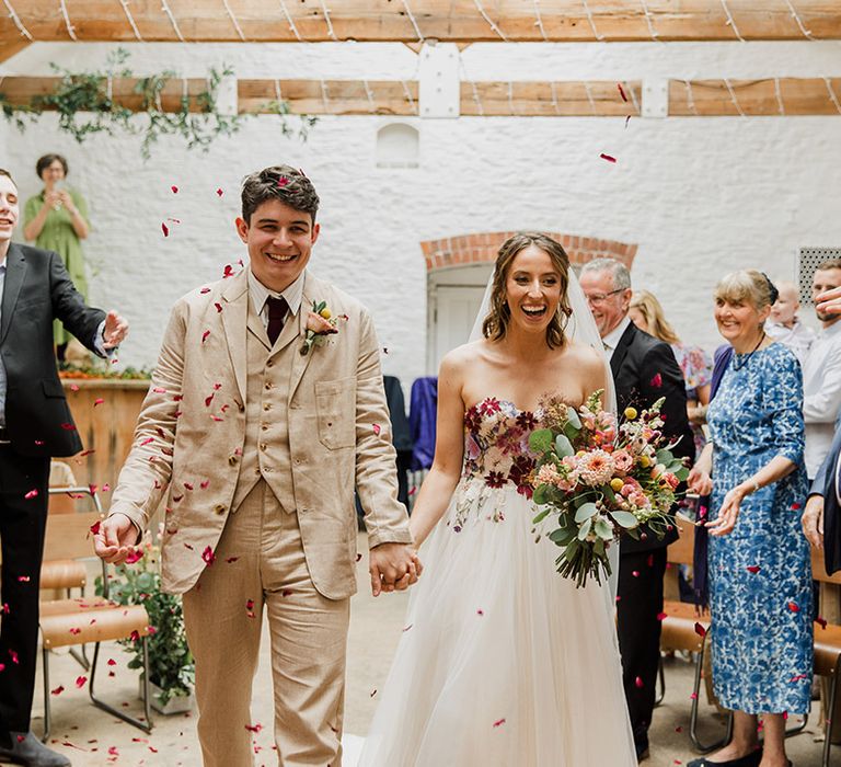 Confetti exit for the bride and groom at The Silk Mill Studios with botanical wedding theme 