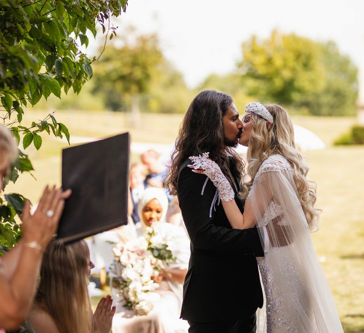 Bride and groom kissing at Euridge Manor wedding ceremony 