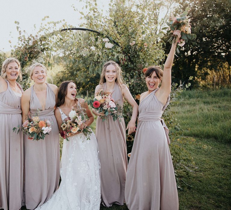 fun bridal party portraits with bridesmaids in dusky pink dresses 