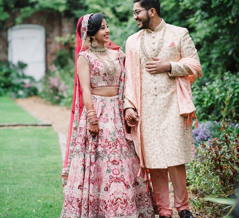 Indian bride and groom in pink wedding attire at Northbrook Park 