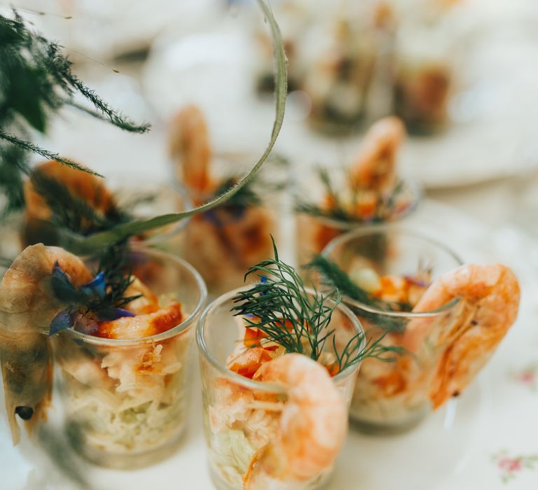 Seafood hors d'oeuvres for the guests on a rose plate with sprigs of flowers