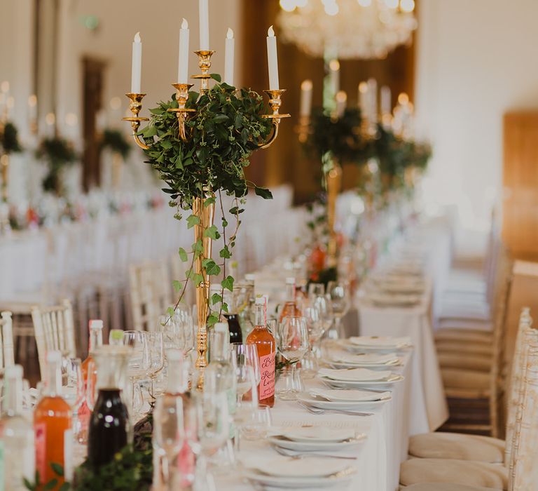 Gold candelabras wrapped in ivy at botanical wedding 