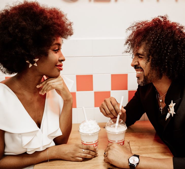 Bride & groom sit in booth at Five Guys