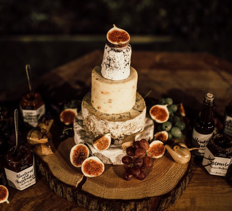 Cheese tower for wedding reception on wooden table 