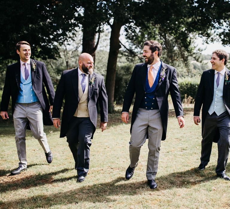 Groomsmen in morning suits with blue, yellow and grey waistcoats 